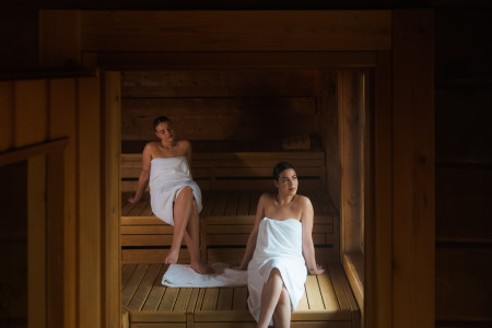 Twee dames ontspannen in handdoek in de Stuga sauna.